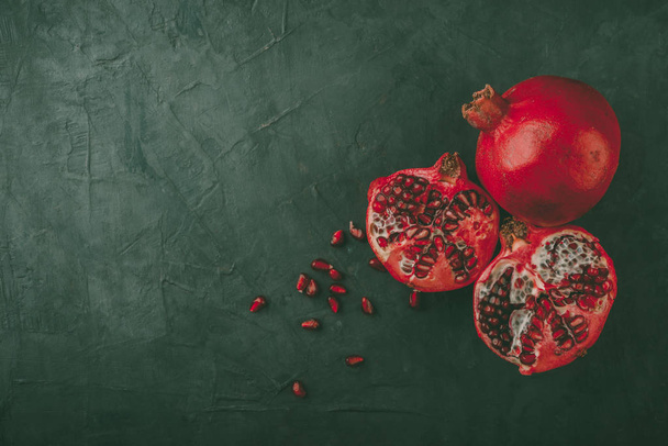  fresh ripe pomegranates on dark background, top view - Photo, Image