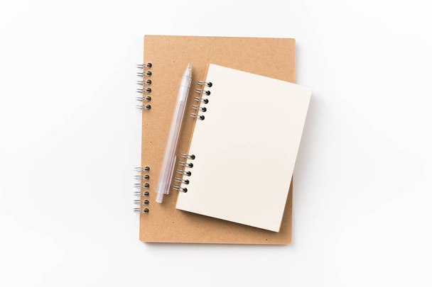 Design concept - Top view of two kraft spiral notebook, blank page, mechanical pencil isolated on white background for mockup - Photo, image