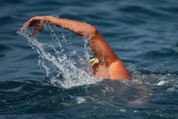 Man swimmer swimming crawl in blue sea - Photo, image