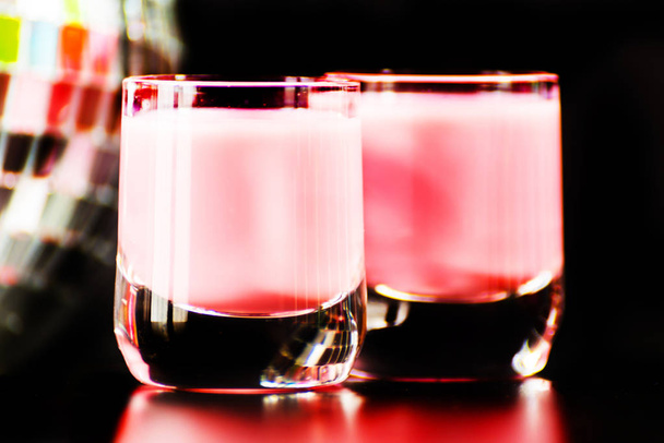 colorful drink shot on disco mirror ball background, refreshing mini drink, party night - Zdjęcie, obraz