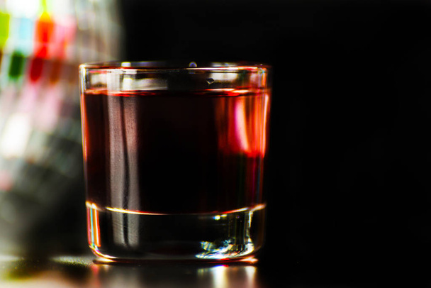 colorful drink shot on disco mirror ball background, refreshing mini drink, party night - Φωτογραφία, εικόνα