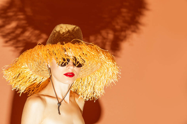 Beautiful woman in hat. Summer vacation woman on bright background. Sunny warm image - Valokuva, kuva