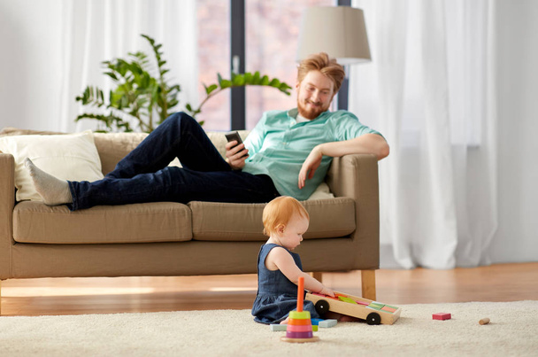 father and baby playing with toy blocks at home - Foto, Imagen