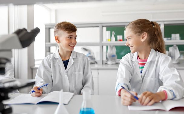 happy kids studying chemistry at school laboratory - Zdjęcie, obraz