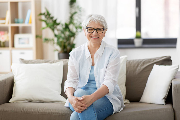 portrait of happy senior woman in glasses at home - Фото, изображение