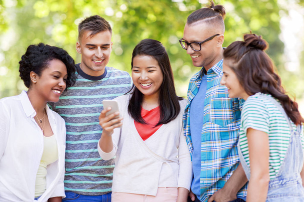 group of happy friends with smartphone outdoors - Photo, image