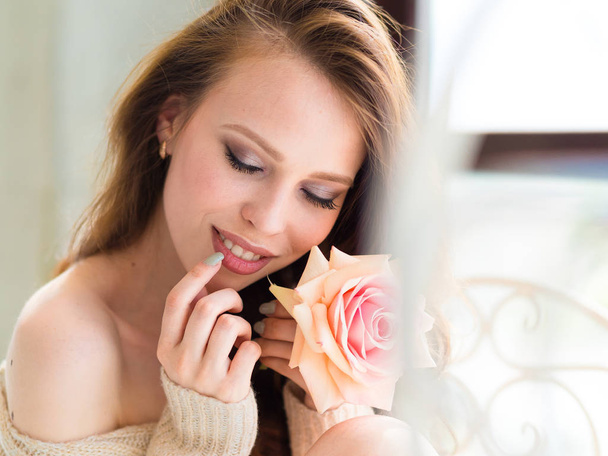 Beautiful girl with rose. Photo of happy brunette girl. Youth and skin care concept - Фото, изображение