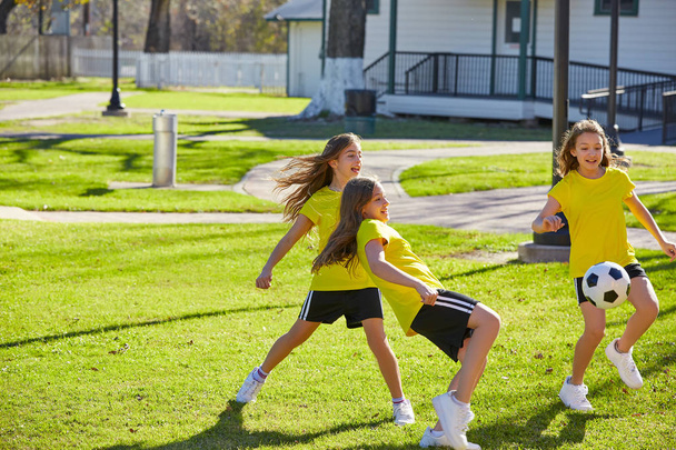 Friend girls teens playing football soccer in a park turf grass - Zdjęcie, obraz