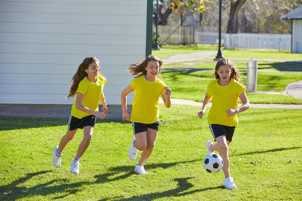 Friend girls teens playing football soccer in a park turf grass - 写真・画像