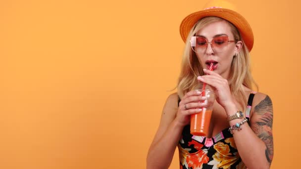 Close up portrait of sexy woman drinking orange juice - Felvétel, videó