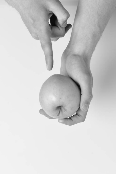 Vitamins and fitness concept. Male hand points on green apple - Foto, Imagen