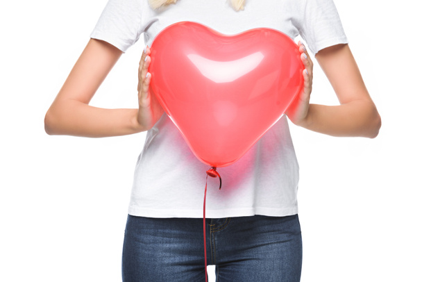 cropped image of girl in white shirt holding heart shaped balloon isolated on white - Photo, Image