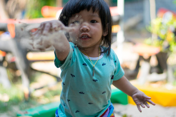 cute happy child playing with toys in a sandbox - Foto, Imagem