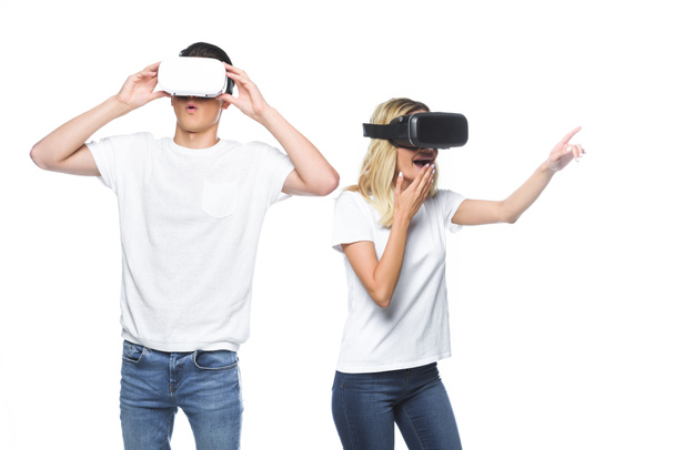 surprised couple using virtual reality headsets isolated on white - Photo, image