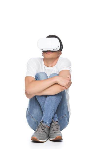 handsome man in white shirt sitting scared with virtual reality headset isolated on white - Fotoğraf, Görsel