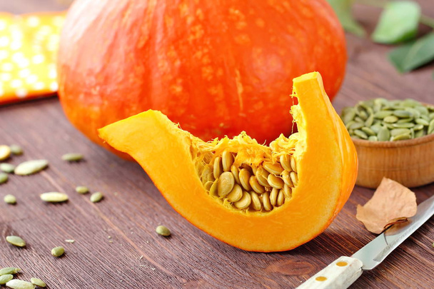 Slice of pumpkin on a wooden table prepared for cooking - Photo, Image