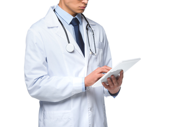 cropped shot of young doctor using tablet isolated on white - Фото, зображення