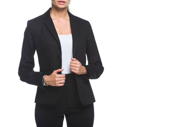 cropped shot of young businesswoman in stylish black suit isolated on white - Фото, изображение