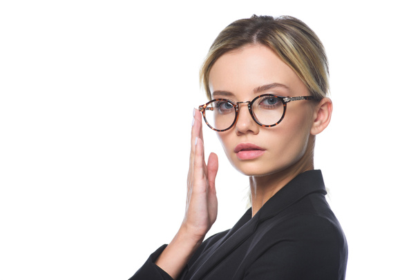 close-up portrait of young businesswoman in suit and eyeglasses looking at camera isolated on white - Photo, image
