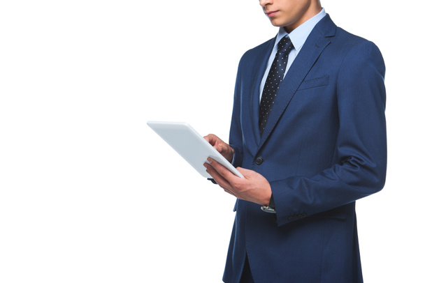 cropped shot of young businessman in stylish blue jacket using tablet isolated on white - Foto, Bild