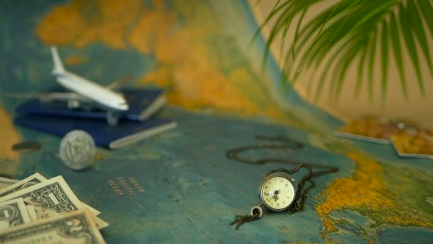 Time to travel concept. Tropical vacation theme with world map, blue passport and plane. Preparing for holliday, journey - Footage, Video