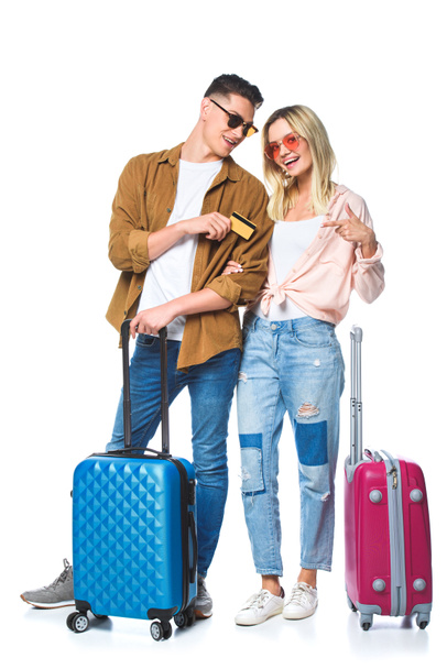 young travelling couple with suitcases and credit card isolated on white - Fotografie, Obrázek