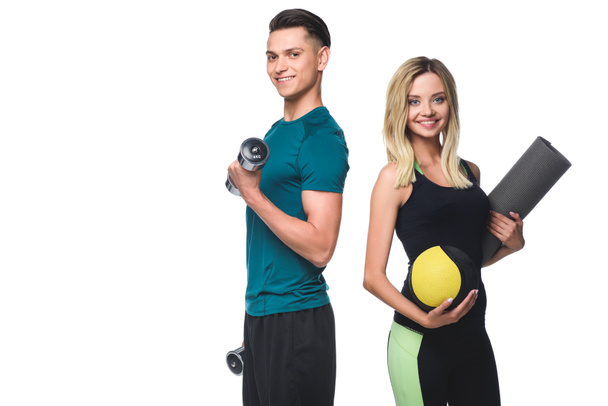 young fit couple with various equipment looking at camera isolated on white - Foto, afbeelding