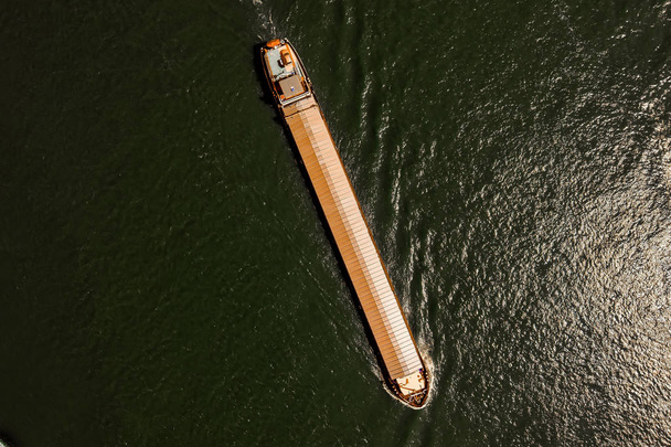 aerial view commercial ship crossing the River Rhine in an area of the Netherland - Foto, imagen
