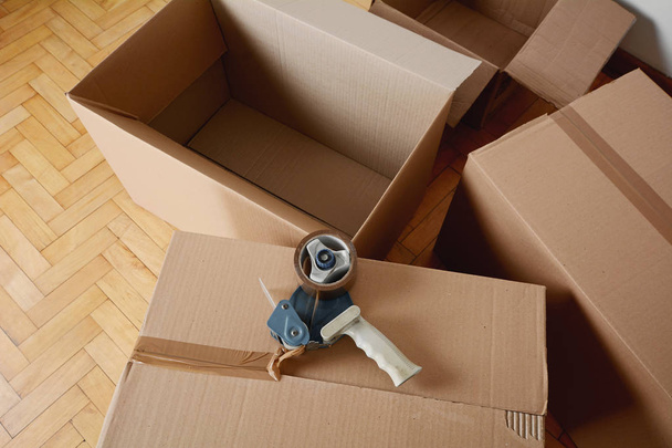 Tape dispenser sealing a shipping cardboard box. Indoors - Photo, Image