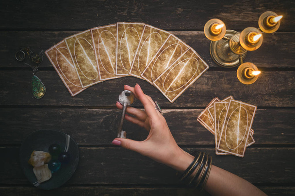 Tarot cards on fortune teller desk table background. Magic key to secrets of fate. Futune reading concept. Divination. - Fotó, kép