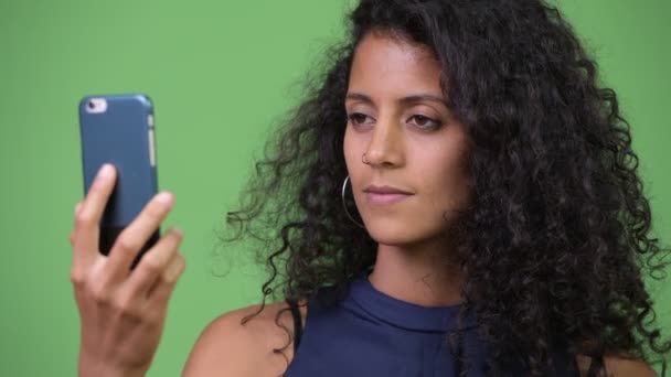 Young beautiful Hispanic businesswoman using phone - Video, Çekim