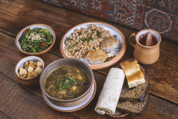 Натюрморт различные вкусные блюда, включая закуски, основное блюдо, сладкий компот в ресторане на Ближнем Востоке - Фото, изображение