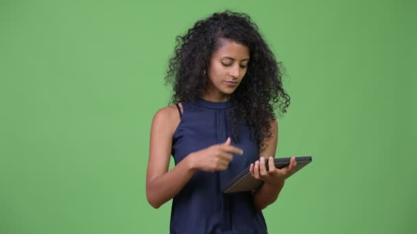Young beautiful Hispanic businesswoman using digital tablet - Materiaali, video