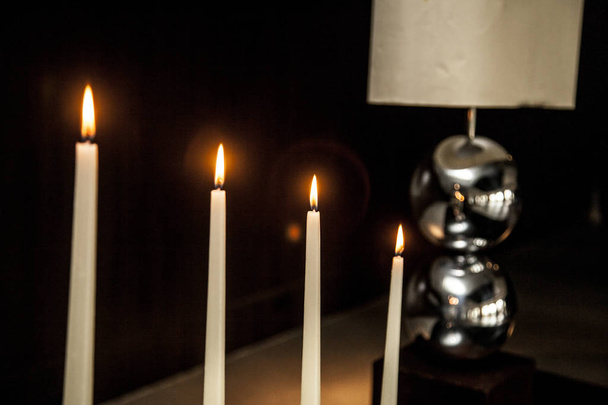candles and lamp on a table in a living room. decoration concept - Foto, immagini