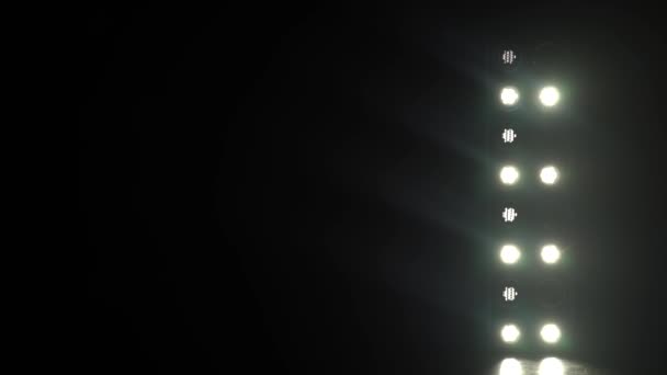 Scheinwerfer scheinen durch die Dunkelheit auf der Bühne - Filmmaterial, Video