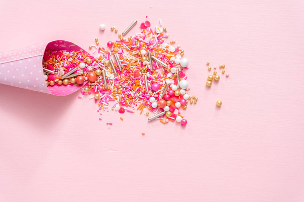 Colorful pink sprinkle blend on a pink background. - Photo, Image