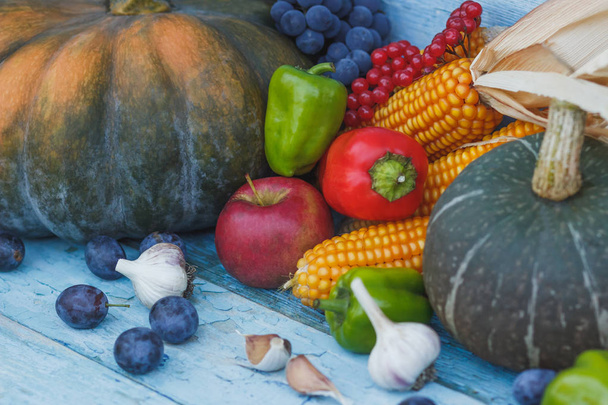 Pumpkin, fruits and different ripe vegetables, wooden background - Zdjęcie, obraz