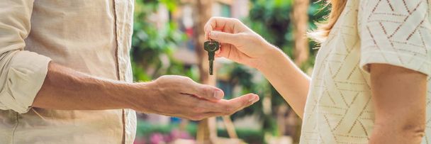 Real estate agent giving keys to apartment owner, buying selling property business. Close up of male hand taking house key from realtor. Mortgage for purchasing flat, getting access to own home. BANNER, long format - Zdjęcie, obraz