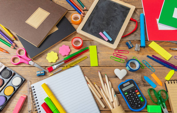 Back to school concept. School supplies on wooden background, view from above - Photo, Image