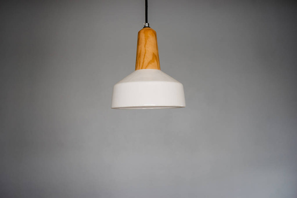 Ceramic white and brown lamp on gray walls. - Φωτογραφία, εικόνα
