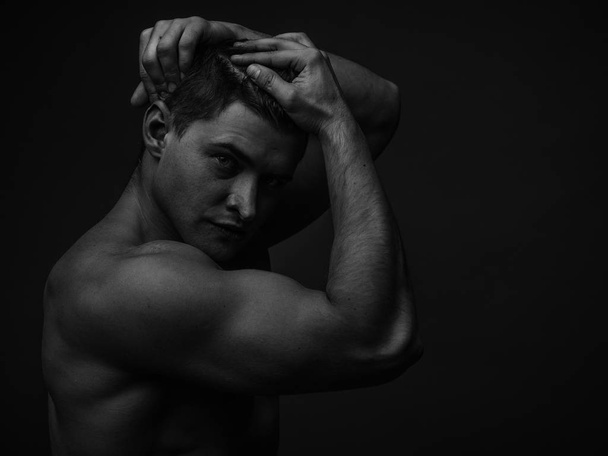Portrait of a young caucasian male athlete with naked torso, black and white - Fotografie, Obrázek
