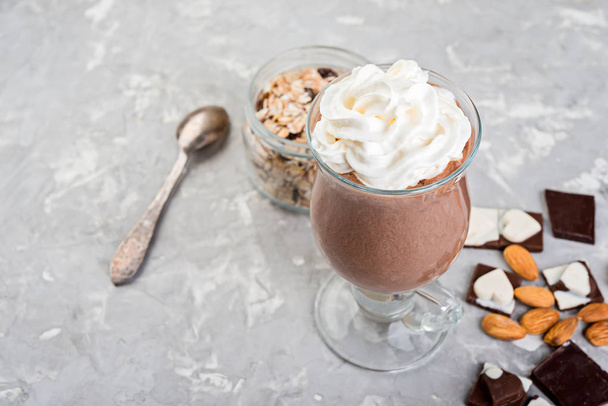 Chocolate smoothie with banana and nuts  on a grey stone  table. - Zdjęcie, obraz