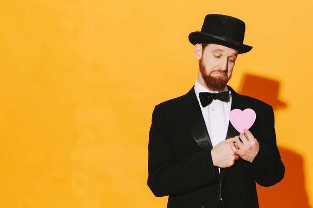 Sad man with top hat holding a pink heart, be my valentine	 - Photo, Image