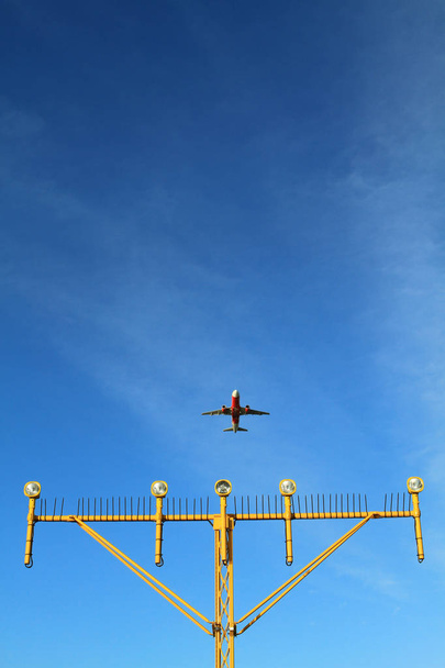 Airport landing lights with airplane approaching runway lighting and radar - Photo, Image