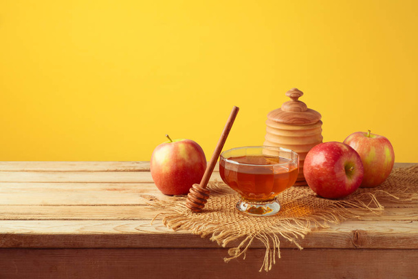Honey and apples on wooden table. Jewish holiday Rosh Hashanah background - Фото, изображение