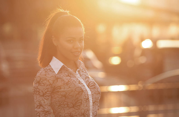 Close up portrait of a beautiful african american woman smiling with sunset - Foto, Bild