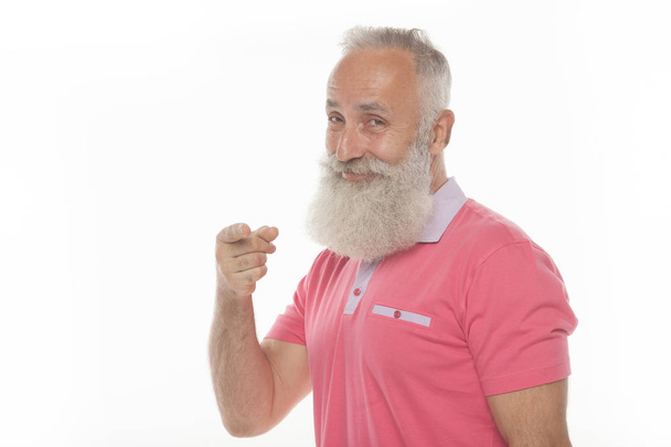 Portrait of a smiling bearded man pointing fingers away isolated on a white background - Foto, immagini
