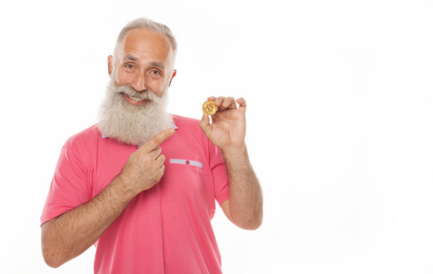 Gold Bitcoin in funny bearded man hand, Digital symbol of a new virtual currency. - 写真・画像