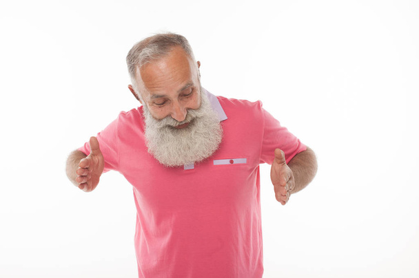 Happy smiling senior bearded man holding something imaginary in  hand. - Zdjęcie, obraz