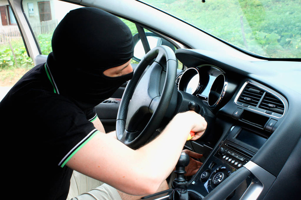 The malefactor in the mask stealing car - Photo, Image